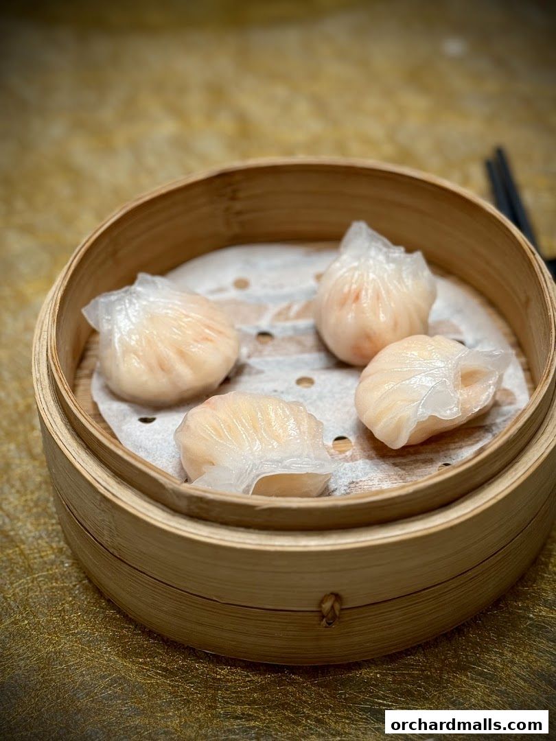 A close-up shot of delicate steamed dumplings in a bamboo steamer.