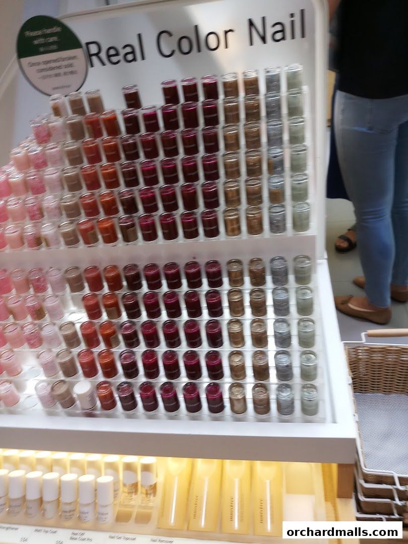 Display of various nail polish colors and other beauty products at Innisfree.