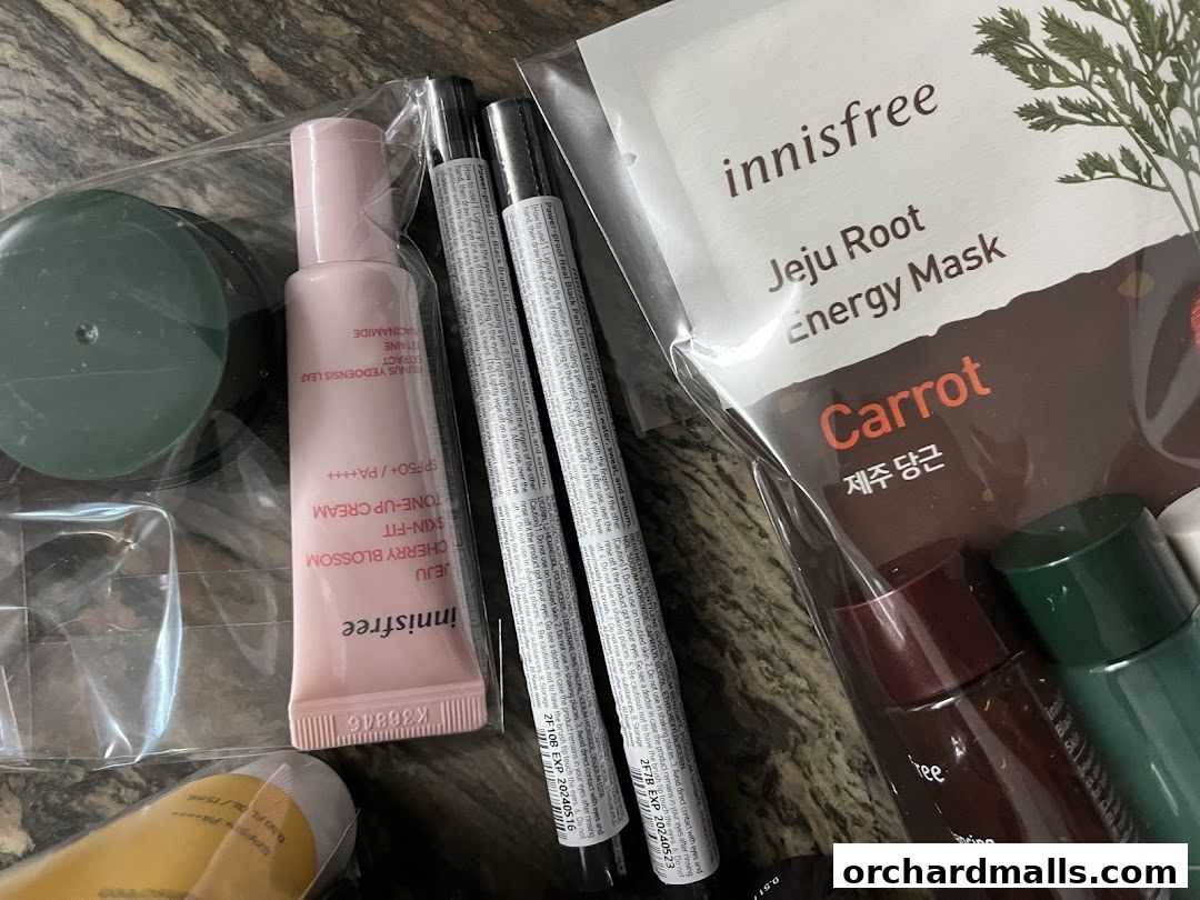 A close-up of various innisfree skincare products, including a mask, tone-up cream, and eyeliner.