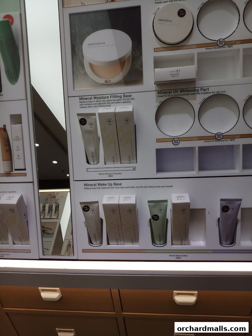 Innisfree makeup products displayed on shelves, featuring bases and powders.