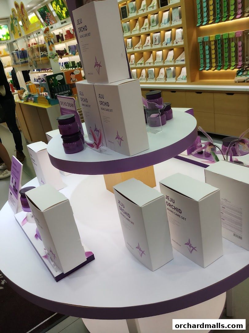 Innisfree shop display featuring Jeju Orchid Aging Care Set products.