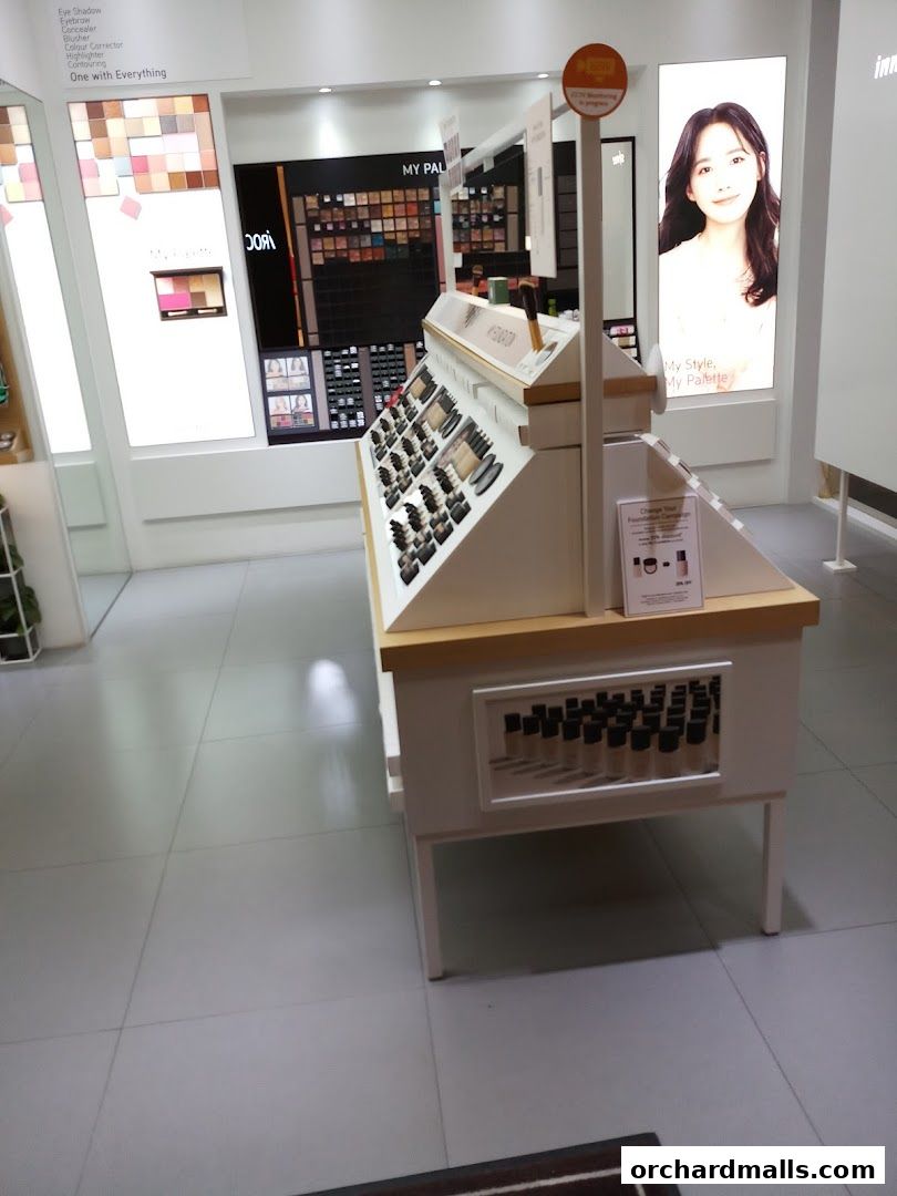 Innisfree makeup display featuring foundations, eyeshadows, and blushes.