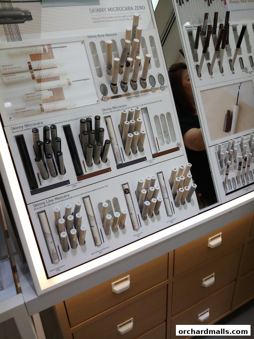 Innisfree display featuring various mascaras and brow products.