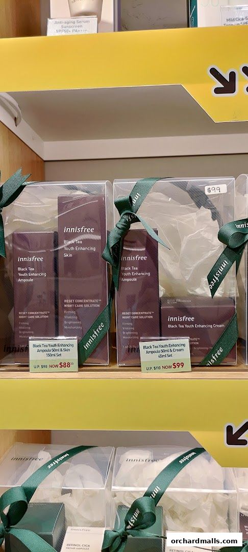 Innisfree Black Tea Youth Enhancing skincare sets are displayed on shelves with pricing.