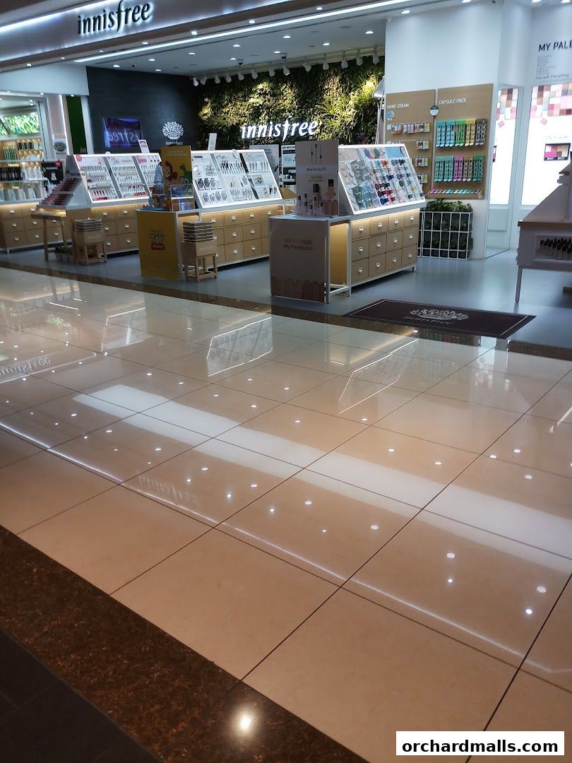 Innisfree store interior showcasing various skincare and makeup products on display shelves.