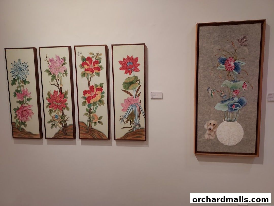 Four vertical floral paintings and one larger painting with flowers and a dog.