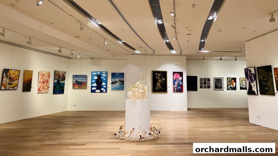 Interior view of an art gallery showcasing diverse paintings and a central sculpture.