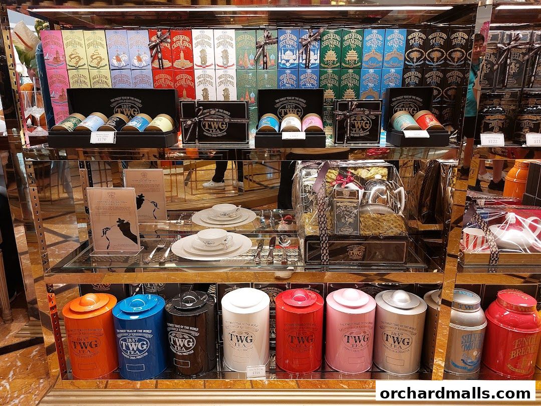 A display of TWG tea products including tea tins, gift sets, and tea ware.