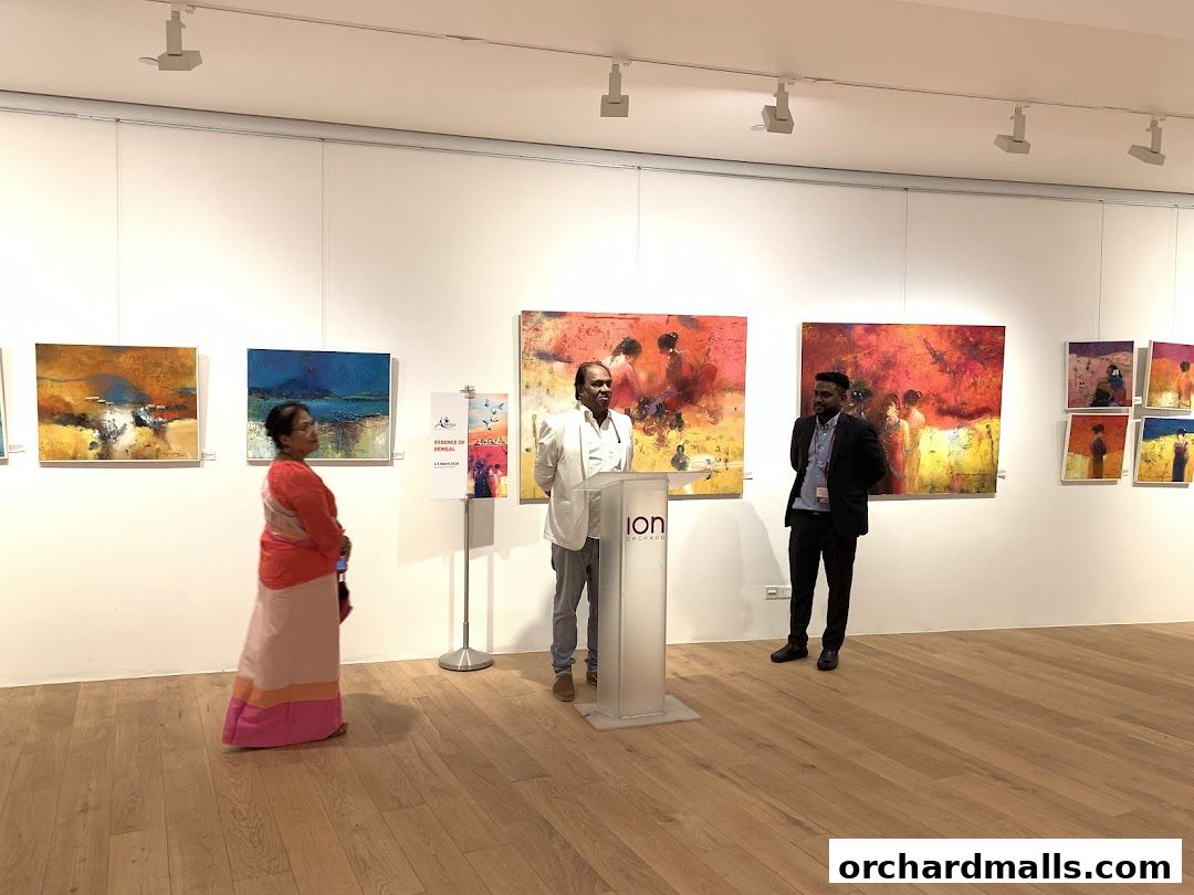 An art exhibition with paintings on display and people observing.