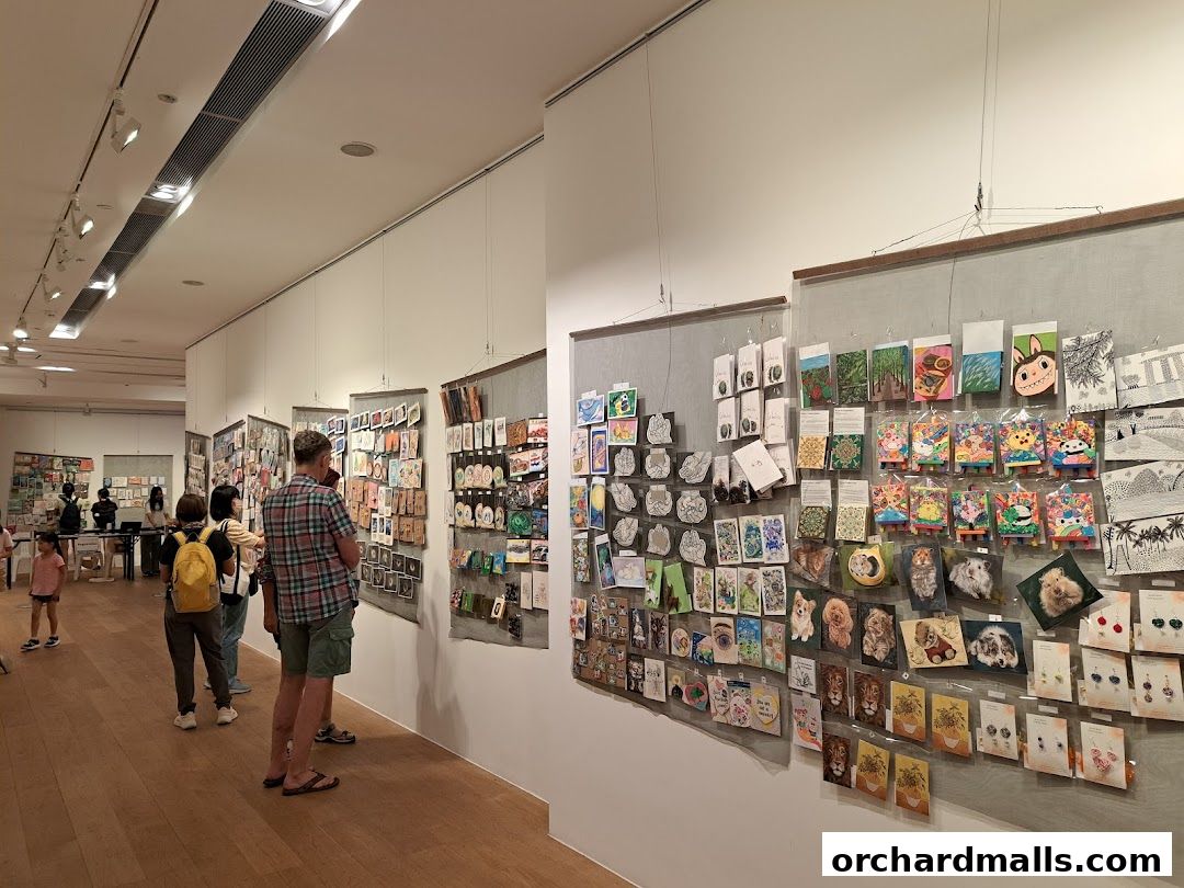 Visitors browse a diverse collection of art prints and merchandise displayed on gallery walls.