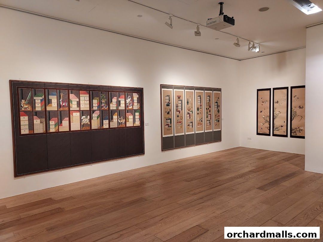 Interior view of an art gallery showcasing various paintings and artworks on display.