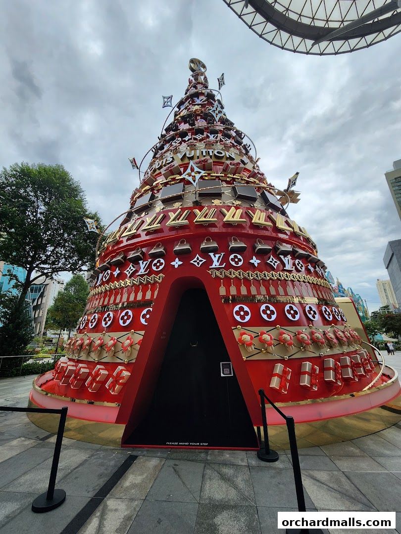 A large, festive Christmas tree decorated with Louis Vuitton logos and gift boxes.