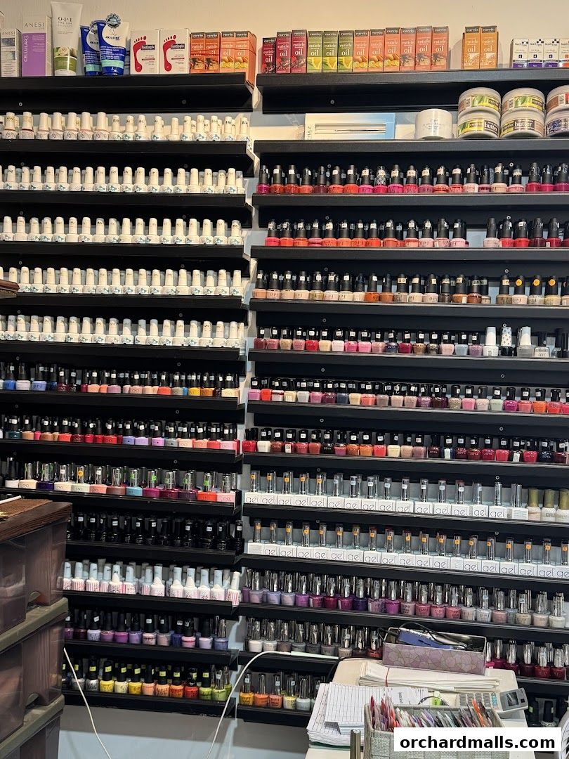 Shelves stocked with a vast collection of nail polish and beauty products.