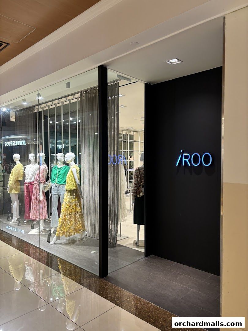 The storefront of iROO Ngee Ann City, featuring mannequins in colorful outfits and the shop's logo.