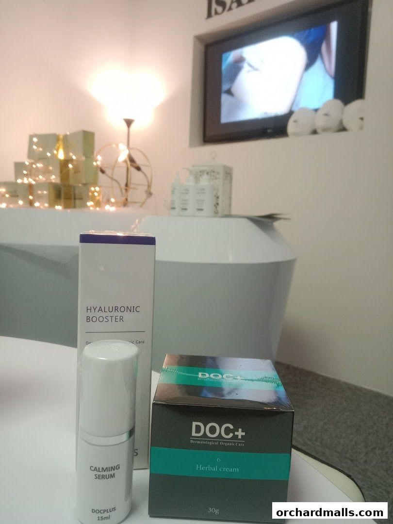 Skincare products including serum and herbal cream displayed with decorative lights.