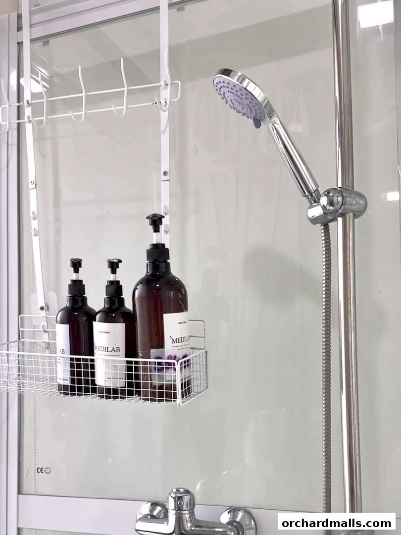 Showerhead and bottles of skincare products on a shelf in a modern bathroom.