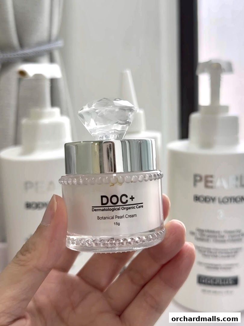 A hand holds a jar of DOC+ Botanical Pearl Cream with a diamond-shaped lid.