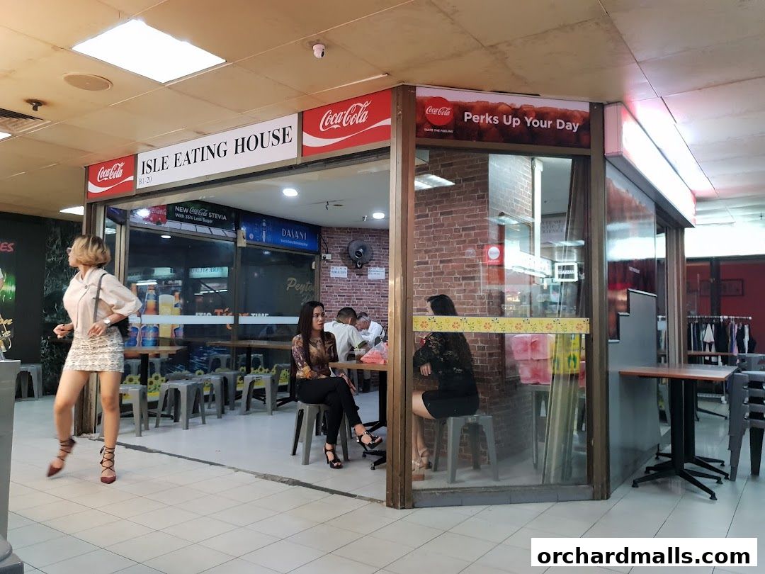 The exterior of Isle Eating House, a casual dining spot with seating visible inside.