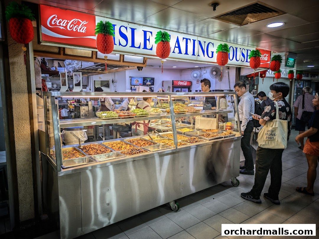 A food stall with a variety of dishes displayed in a refrigerated counter.
