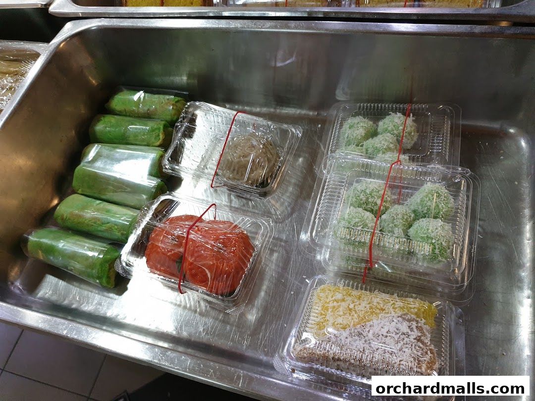 A variety of pre-packaged sweet treats displayed in a metal tray.