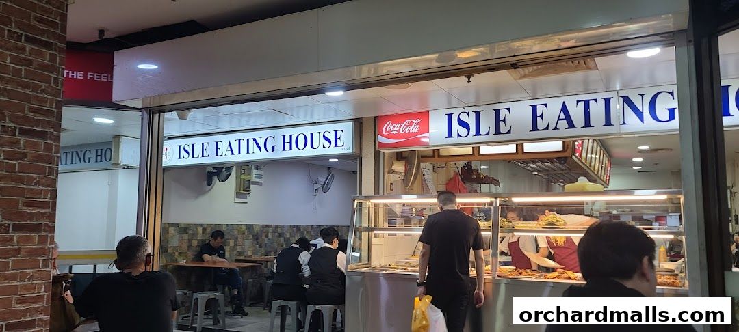 The exterior of Isle Eating House, showing the storefront, seating area, and food display.