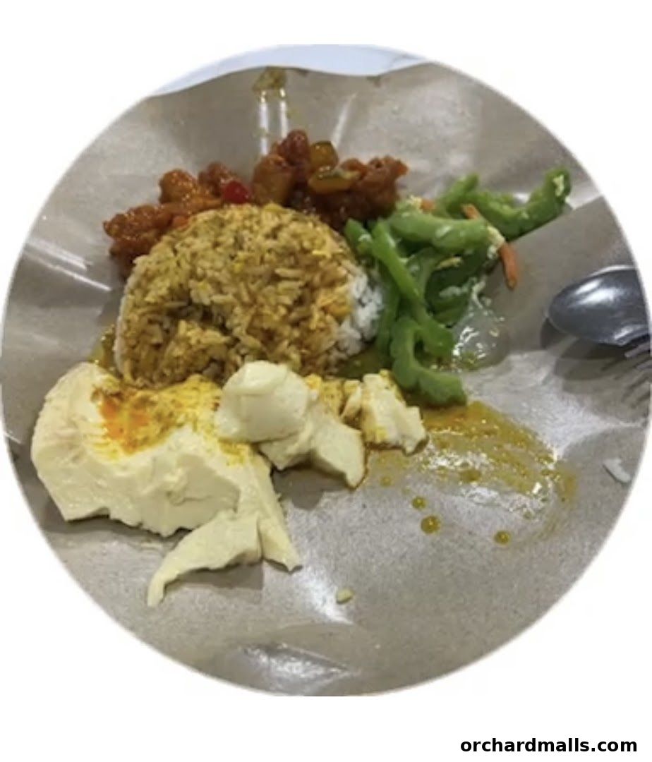 A plate of rice with various side dishes, including tofu, vegetables, and meat.