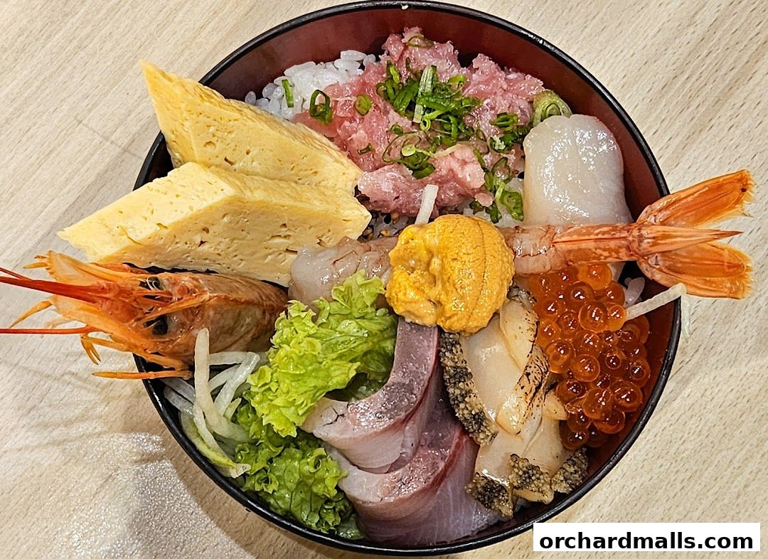 A close-up overhead view of a colorful and abundant Chirashi bowl from Itacho Sushi.
