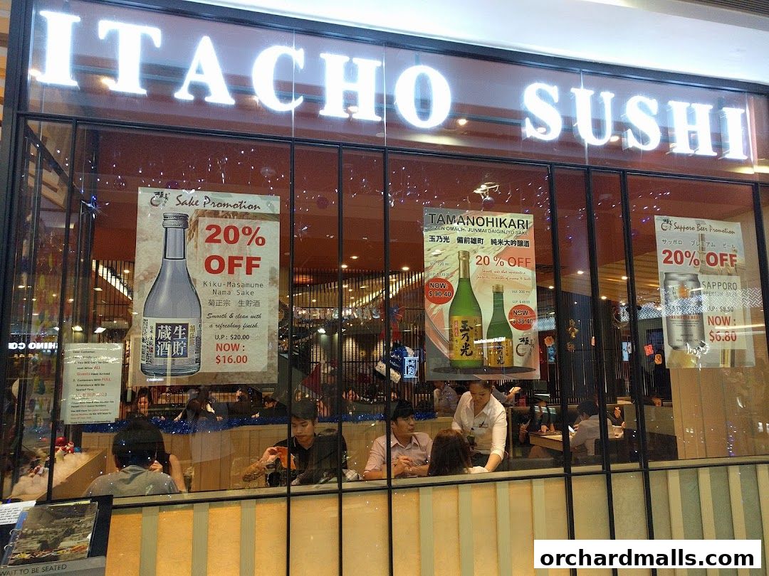 The storefront of Itacho Sushi, featuring promotions for sake and Sapporo beer.