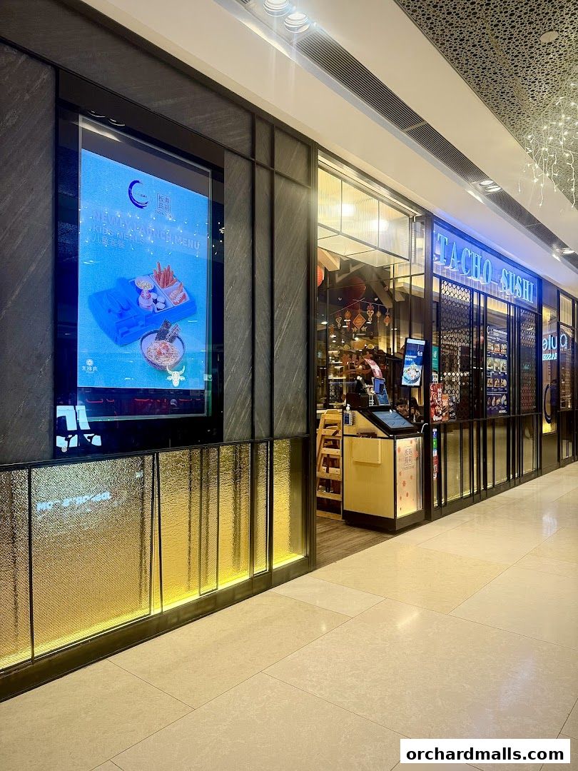 The exterior of Itacho Sushi, a Japanese restaurant, with a digital menu display.