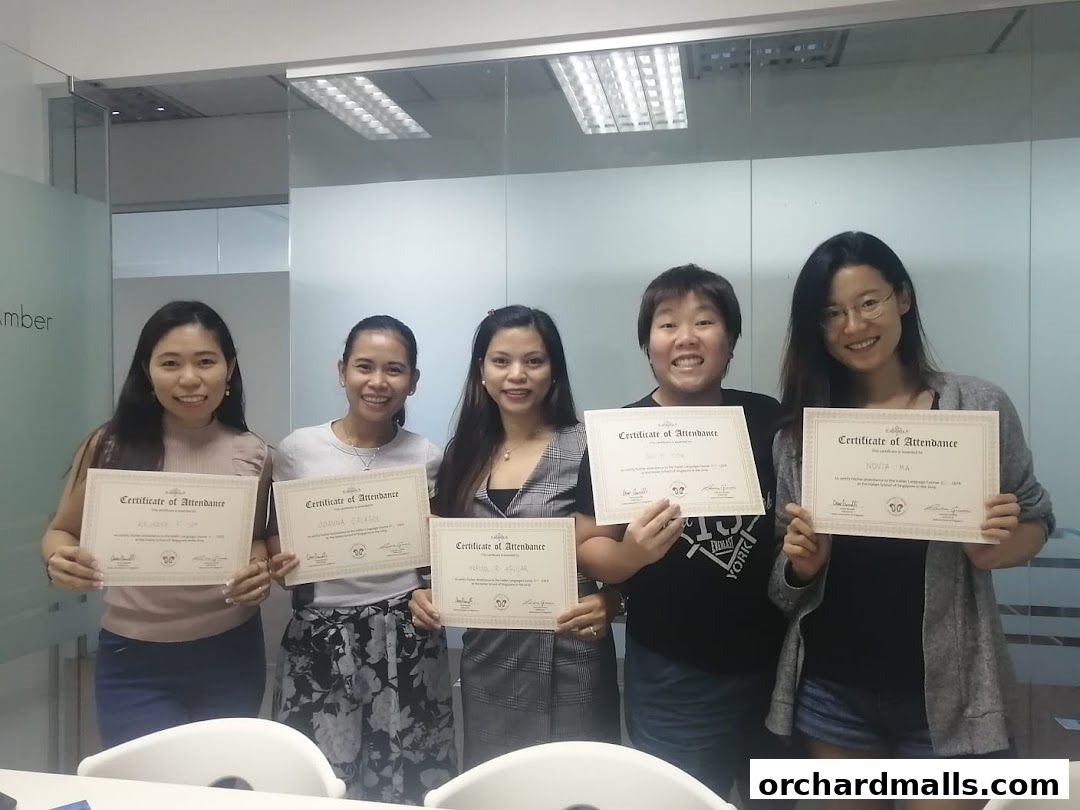 Five smiling women hold up certificates of attendance from an Italian language course.