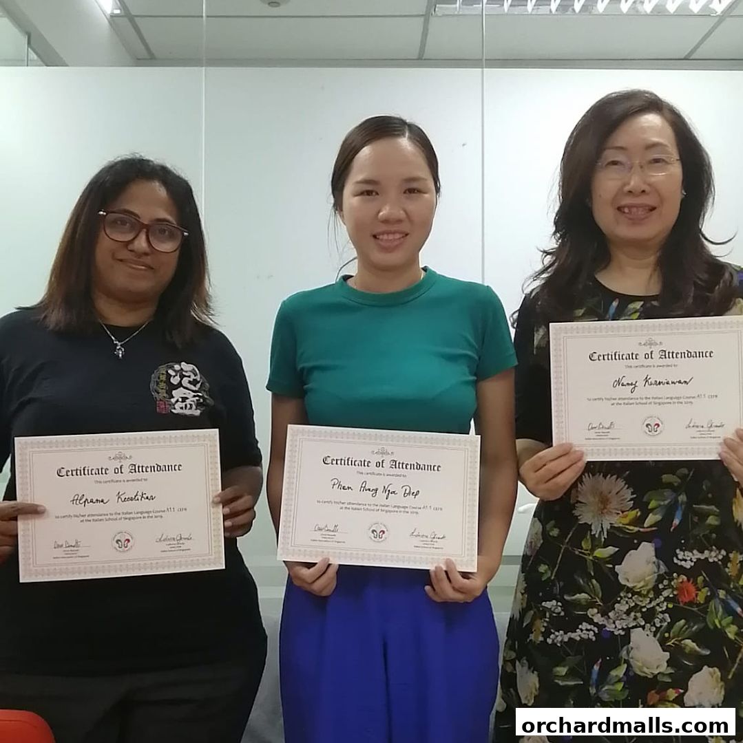 Three women proudly hold certificates of attendance from an Italian language course.