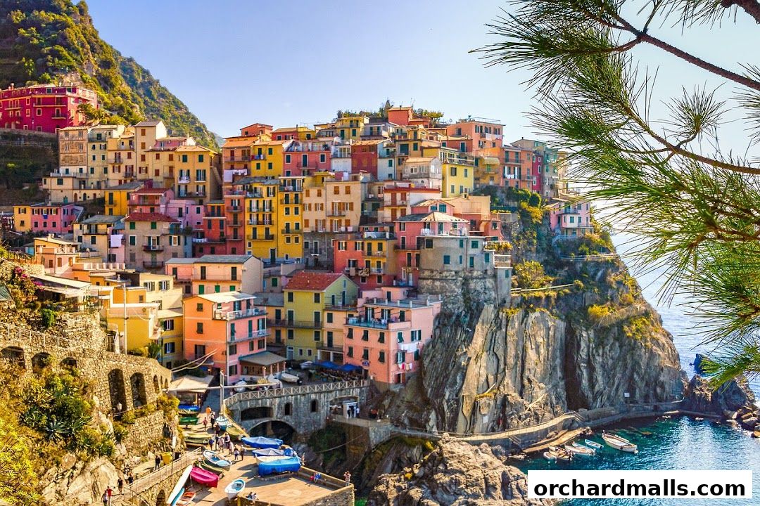 Colorful Italian village perched on a cliff overlooking the sea.