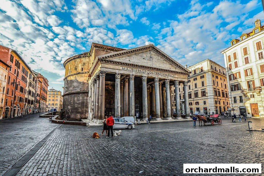 The Pantheon in Rome with surrounding buildings and people on a cobblestone square.
