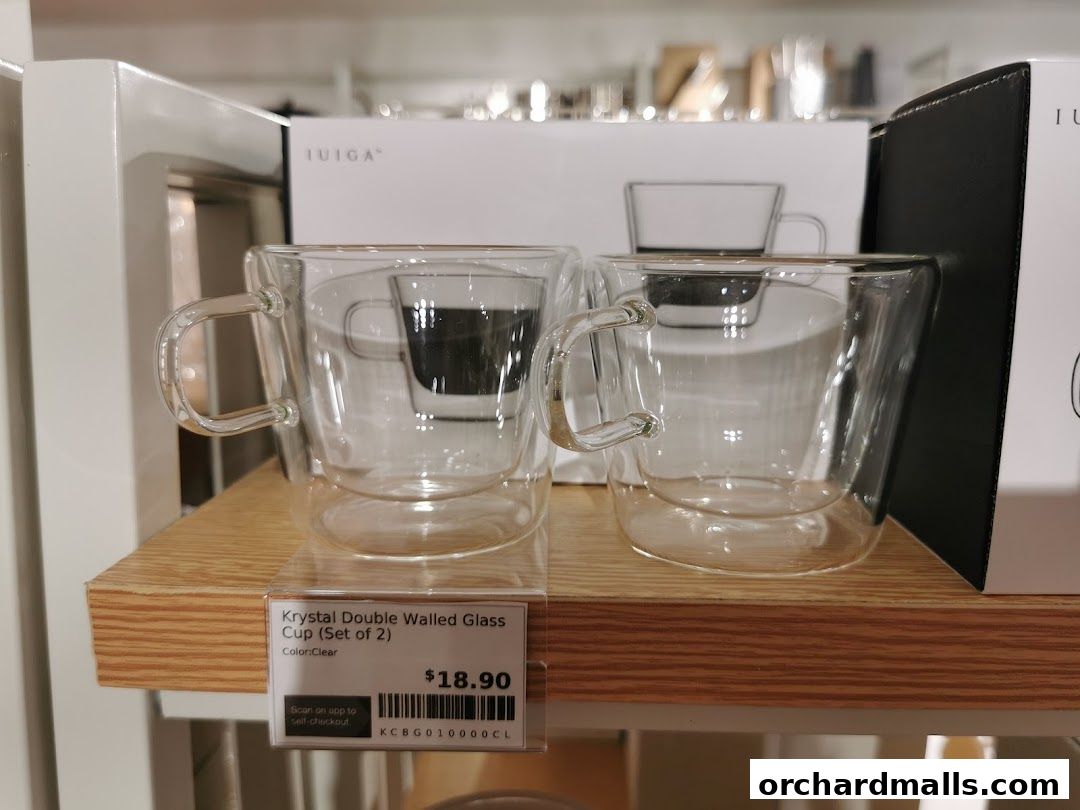 Two clear double-walled glass cups displayed on a shelf with a price tag.