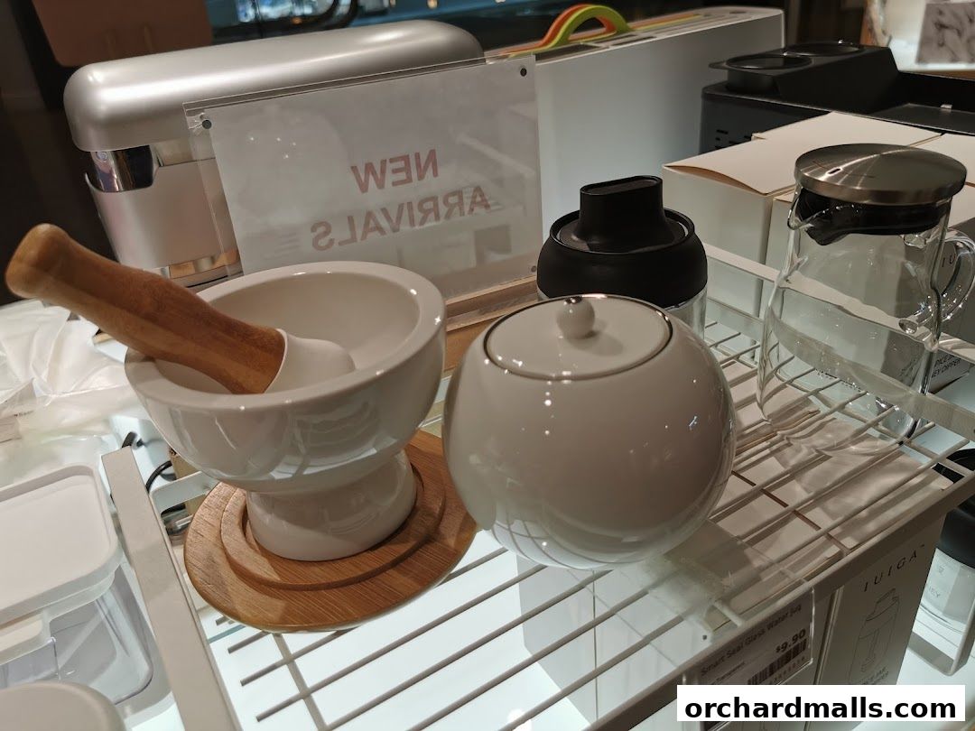 Kitchenware display featuring a mortar and pestle, sugar bowl, and glass pitcher.
