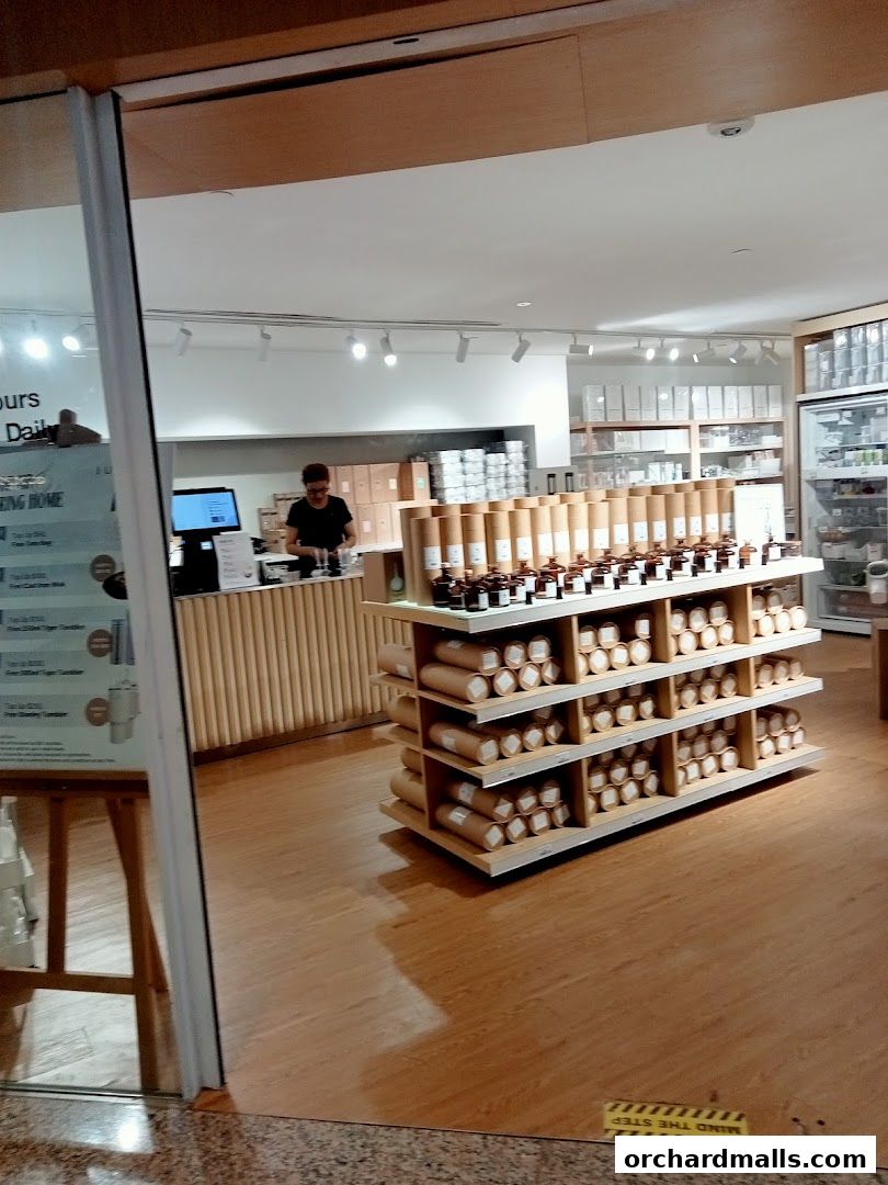 Interior view of a clean, modern retail store with shelves stocked with products.