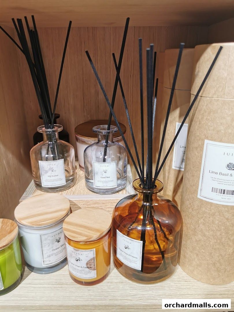 A display of IUIGA scented candles and reed diffusers in various fragrances.