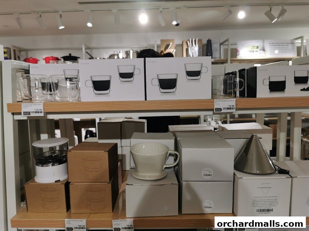 Shelves display various drinkware, coffee makers, and filters from IUIGA.