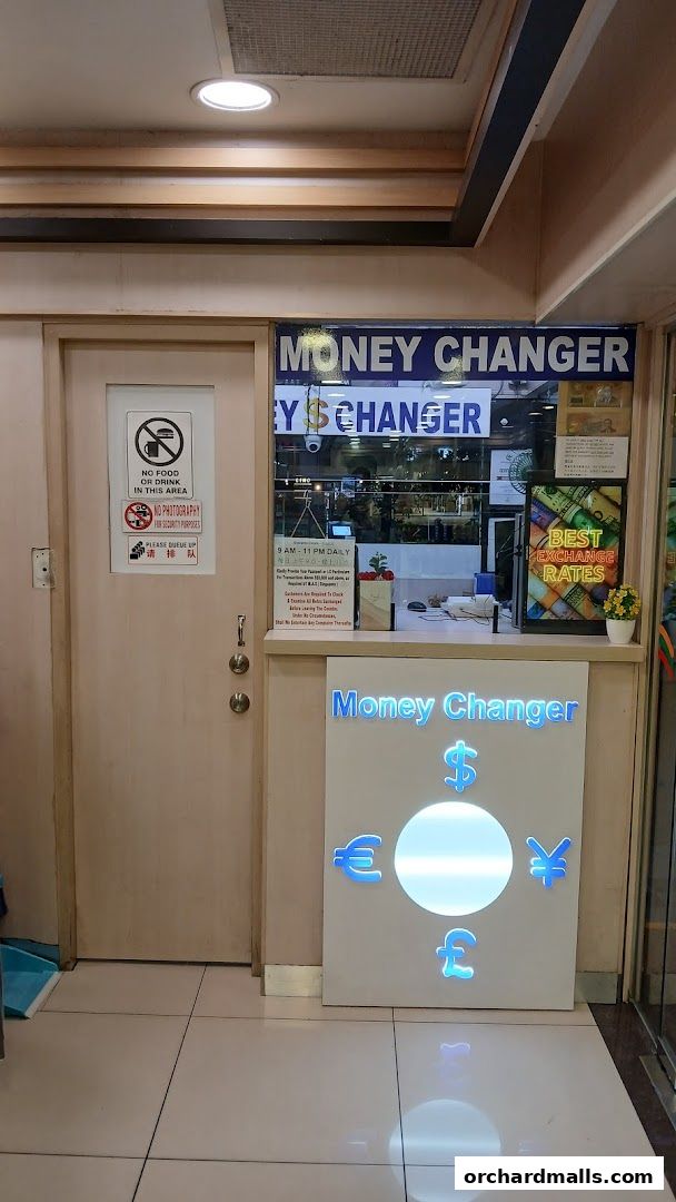 Exterior view of Jaili Money Changer shop with currency symbols and operating hours.
