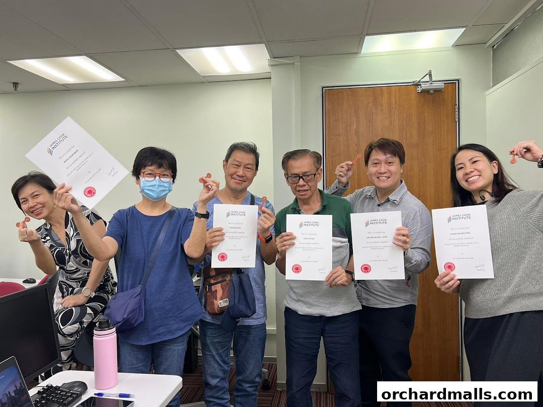 A group of six people proudly holding certificates from James Cook Institute.