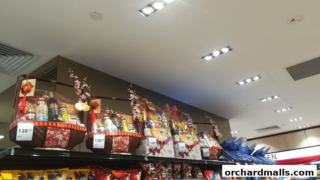 Gift baskets filled with various food items and bottles are displayed on shelves, decorated with festive ornaments.