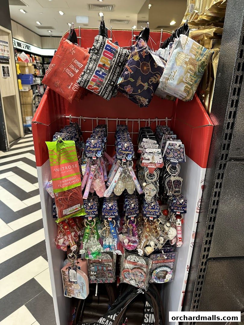 A display rack filled with Singapore-themed souvenirs like pouches and keychains.