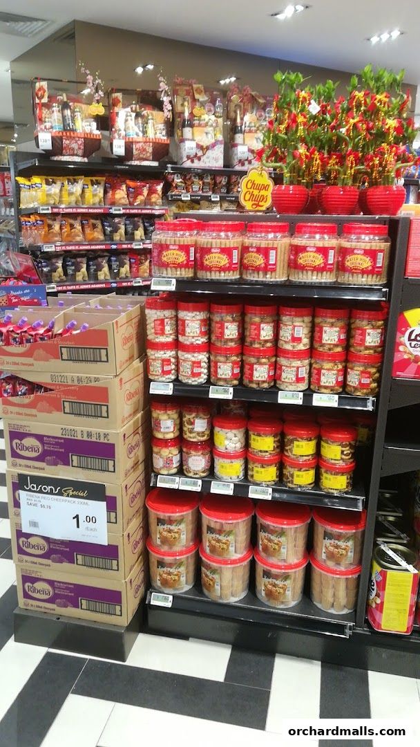 Shelves stocked with various snacks, gift baskets, and drinks, with festive decorations.