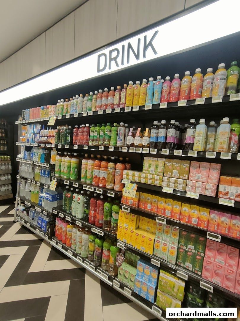 Shelves stocked with a wide variety of bottled drinks and boxed beverages.
