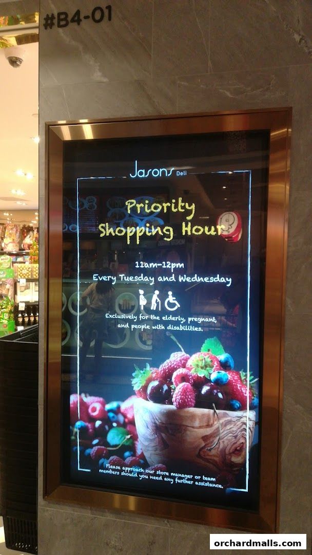 A digital display board announcing priority shopping hours at Jason's Deli.