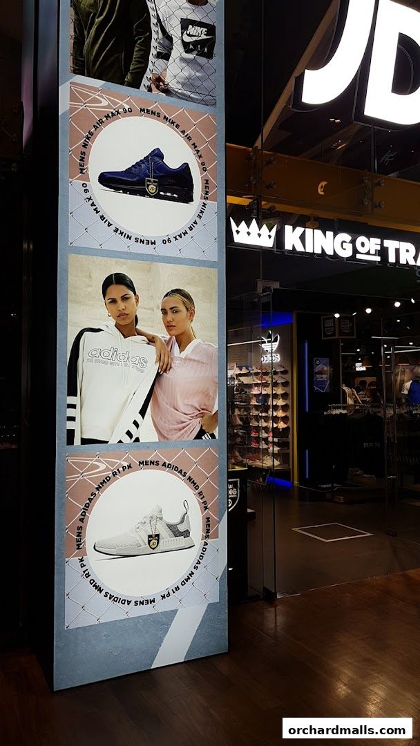 JD King Of Trainers shop entrance with advertising posters for Nike and Adidas footwear.