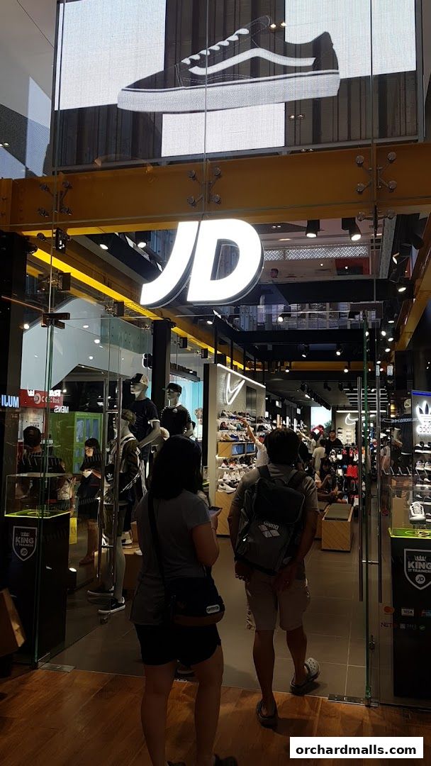 The entrance to JD King Of Trainers, showcasing a large display of sneakers and apparel.
