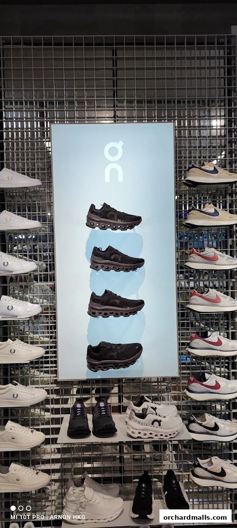 A display of various athletic shoes from brands like ON, Nike, and Fred Perry.