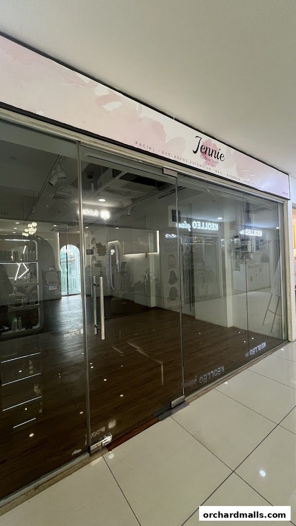 Exterior view of Jennie Eyebrow Studio, showcasing its modern glass facade and interior.