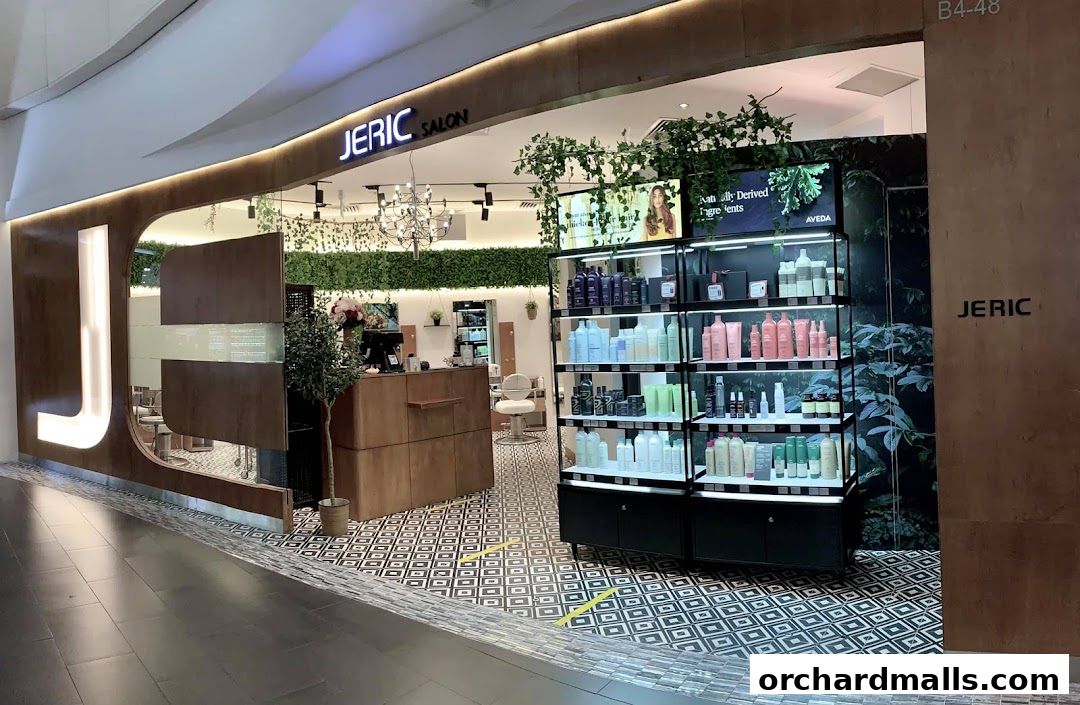 The exterior of JERIC SALON, featuring a modern design with a prominent 'J' logo and a display of hair products.